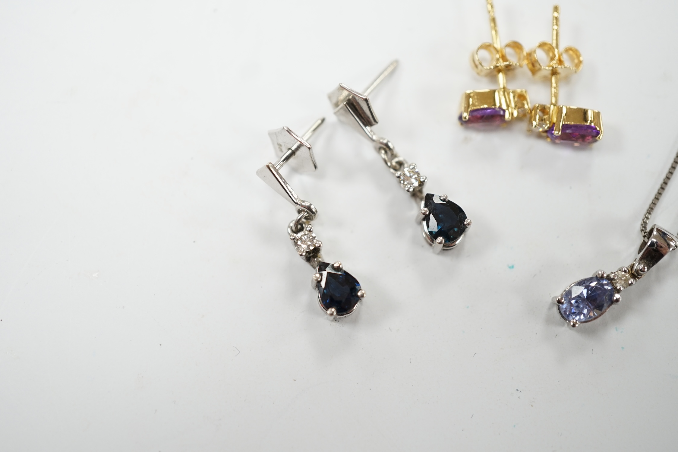 A modern 18ct white gold sapphire and diamond set drop pendant, 13mm, on a 925 chain, together with a modern pair of 750 yellow metal, amethyst and diamond set ear studs and a pair of 9ct sapphire and diamond set ear stu